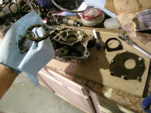 1995 Ford Probe - Disassembled engine oil pump components laid out on a workbench for repair or cleaning.
