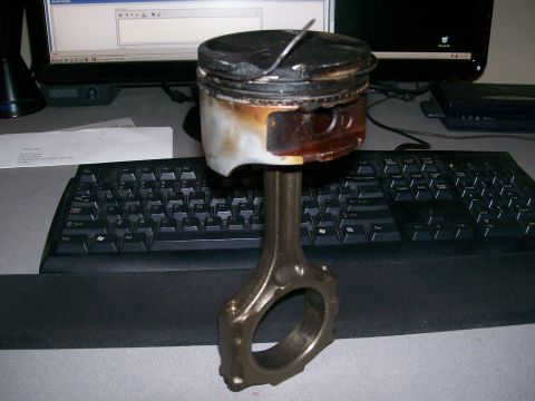 1995 Ford Probe - This engine part shows significant damage and wear, indicating a mechanical failure.