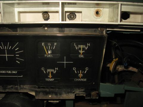 1981 Ford Bronco - The dashboard displays fuel, oil, temperature, and charge gauges, with some wiring visible behind the panel.