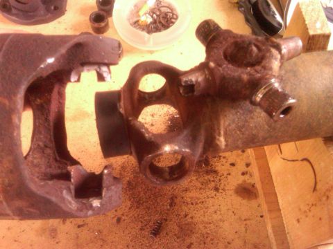 1991 Ford Bronco - Close-up of damaged driveshaft parts, including a broken yoke and a universal joint.