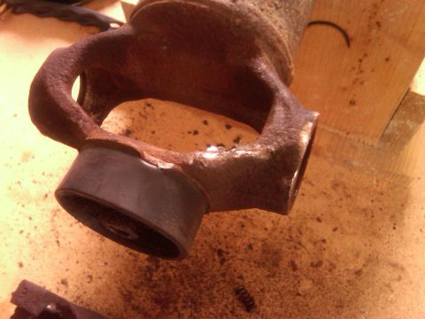 1991 Ford Bronco - This severely corroded driveshaft U-joint shows significant damage to its yoke, indicating a potential failure.