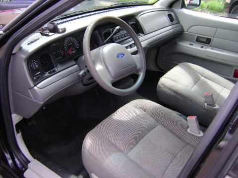 2003 Ford Crown Victoria - The interior of a 2003 Ford Crown Victoria is shown, the driver's side dashboard and front passenger seat.
