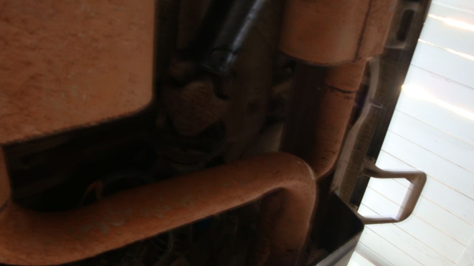 close-up of rusty exhaust pipe and muffler