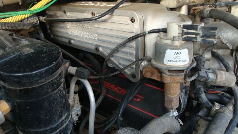 1994 Ford Bronco - Close-up view of engine parts with visible Ford branding and part numbers.