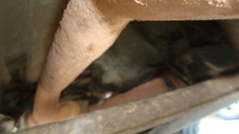 1994 Ford Bronco - Undercarriage view shows rusted exhaust pipes and frame components.