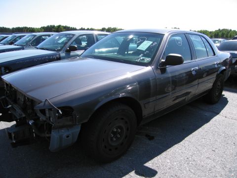1991 Ford LTD Crown Victoria - This sedan appears to be a Ford Crown Victoria, likely from the early 2000s, with damage to its front end.