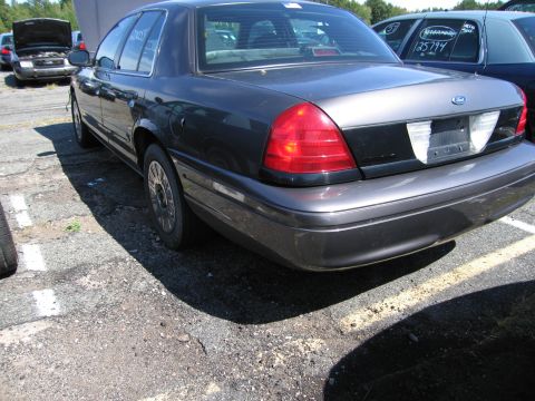 1991 Ford LTD Crown Victoria - Rear view of a Ford Crown Victoria, parked outdoors with other vehicles visible.