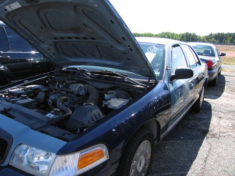 1991 Ford LTD Crown Victoria - Engine bay of a 1991 Ford Crown Victoria LTD, parked outdoors with another vehicle behind.