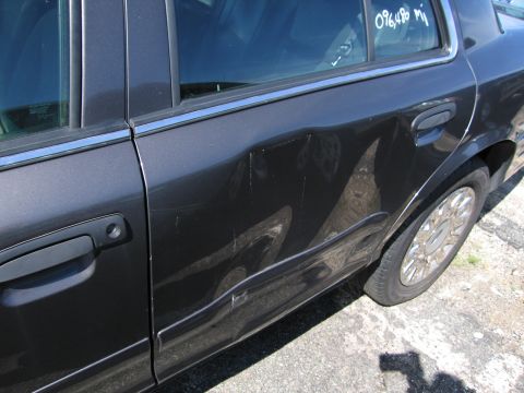 1991 Ford LTD Crown Victoria - Side view of a dark gray sedan showing extensive damage to the rear door and fender area. An odometer reading of 096,486 miles is visible o…