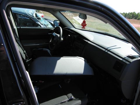 1991 Ford LTD Crown Victoria - Interior view of a car with a damaged windshield and a visible air freshener hanging from the rearview mirror.