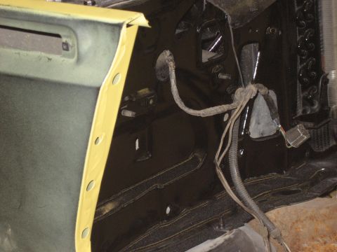 1978 Ford Bronco - Close-up view of the interior of a vehicle, showing a door frame with yellow tape and exposed wiring.