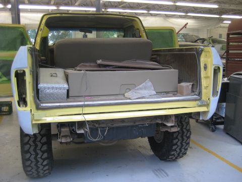 1978 Ford Bronco - Rear view of a 1978 Ford Bronco in a garage, undergoing restoration or repair.