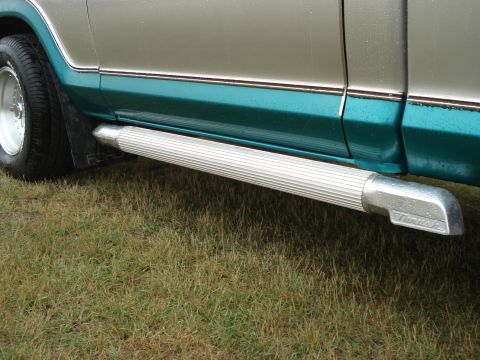 1979 Ford F-150 - Close-up of a truck's side step and lower body panels with two-tone paint.