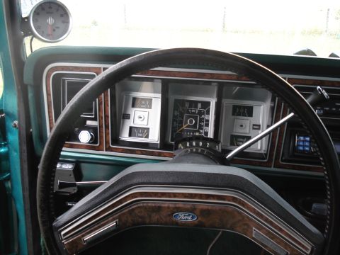 1979 Ford F-150 - The interior of a 1979 Ford F-150 features wood grain accents and a prominent tachometer above the dashboard.
