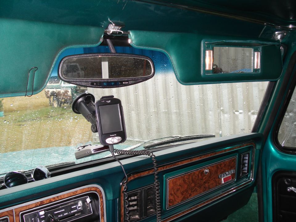1979 Ford F-150 interior showing dashboard, rearview mirror, GPS mount, and wood grain trim