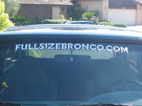 1995 Ford Bronco - Interior view of a dark SUV, a custom windshield banner that reads "FULLSIZEBRONCO.COM".