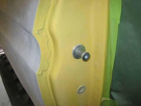 1978 Ford Bronco - A close-up view of a car door's interior panel, showing a knob and screw, with masking tape applied to the edge.