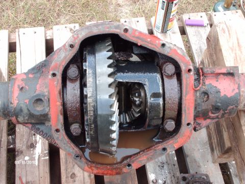1982 Ford F-100 - Differential housing with internal gears and fluid, resting on wooden planks.