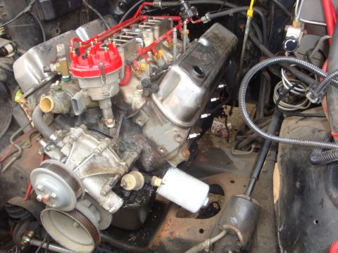 1989 Ford Bronco - Close-up view of a V8 engine, showing the distributor, spark plug wires, and fuel filter assembly.