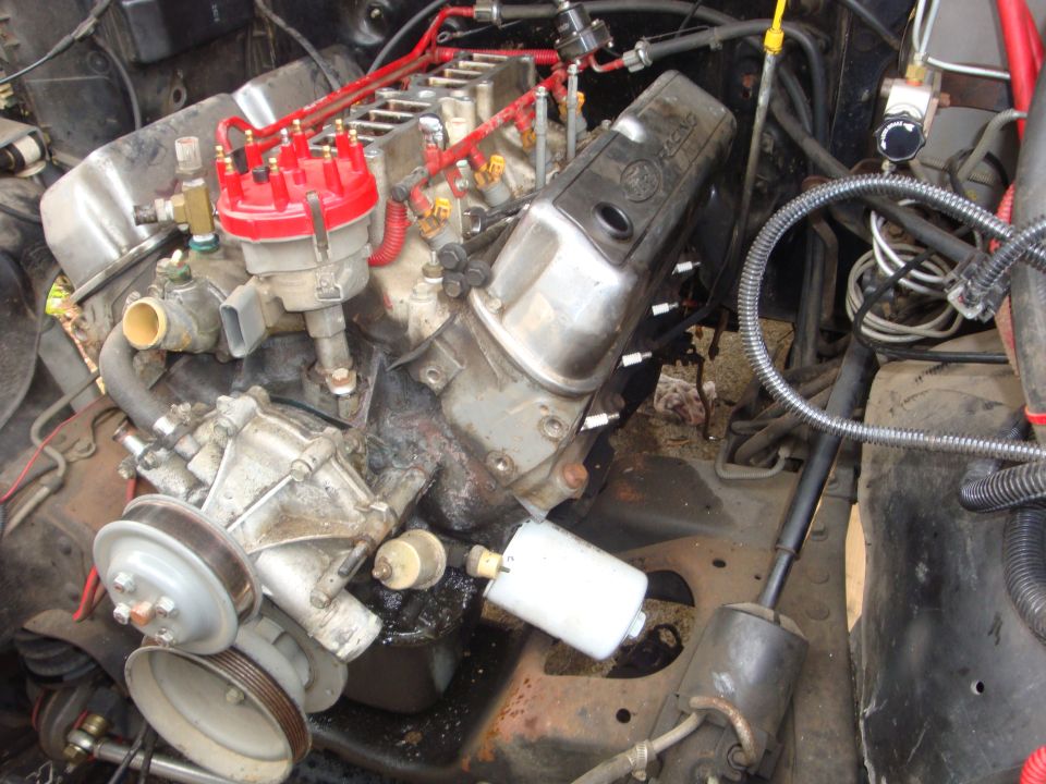 engine bay with V8 engine, distributor, spark plug wires, and fuel filter