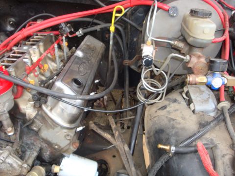1989 Ford Bronco - Close-up view of a vehicle's engine bay, showing various components and wiring.