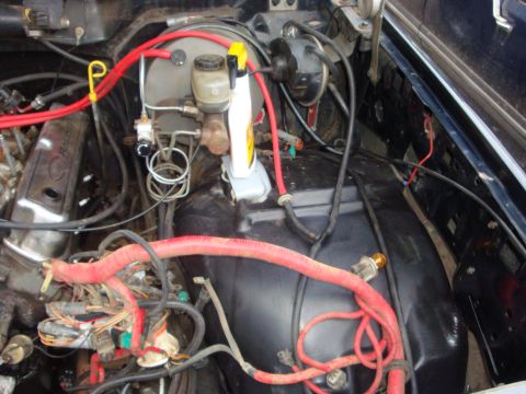 1989 Ford Bronco - Close-up view of a vehicle's engine bay, focusing on the brake system components and wiring.