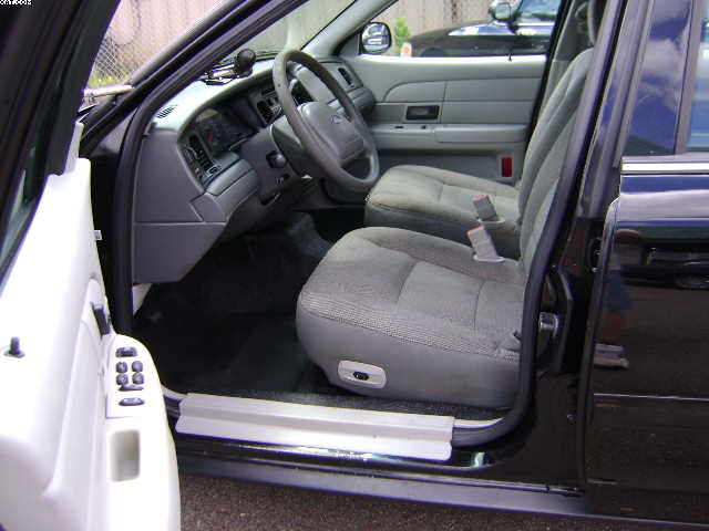 Interior view of a 2003 Ford Crown Victoria, showing the front seats, dashboard, and steering wheel