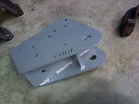 1995 Ford Bronco - Metal bracket with 'CAGE' stamped into it, likely a custom automotive part.