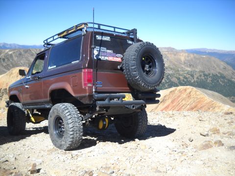 1986 Ford Bronco II - Modified 1986 Ford Bronco II on a mountain overlook, showing its off-road capabilities.