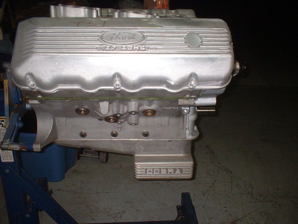 Ford 427 SOHC engine with "COBRA" lettering on a stand