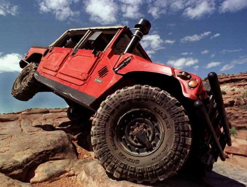 1998 Ford Crown Victoria - Red Hummer H1 navigates a challenging rocky off-road course.