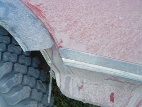 1988 Ford F-150 - A close-up view of a vehicle's side, showing a dusty fender and a large tire. The Supermotors.net watermark is visible.