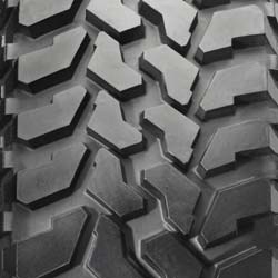 1988 Ford Bronco - This image shows a close-up of a tire's tread pattern, the SuperMotors logo and website.