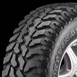 1988 Ford Bronco - Off-road tire with prominent tread pattern and visible text on the sidewall.