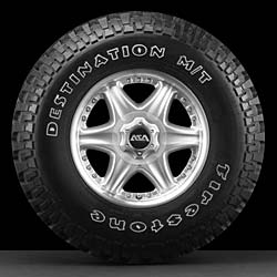 1988 Ford Bronco - Close-up of a Firestone Destination M/T tire mounted on a silver alloy wheel.