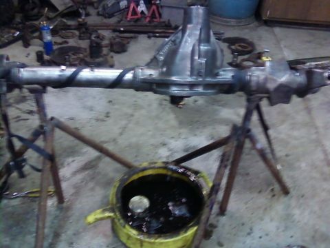 1995 Ford Bronco - A differential axle assembly is shown on stands, with a drain pan beneath it.