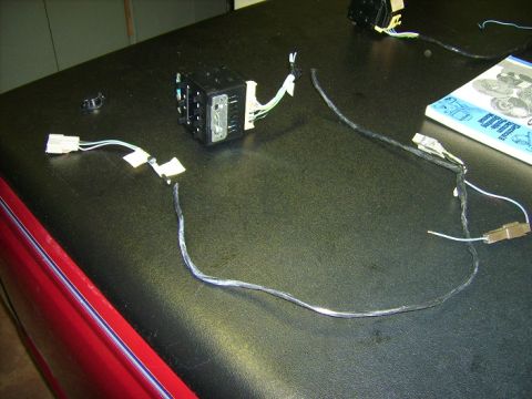 1988 Ford Crown Victoria LTD - Electrical control module and wiring laid out on a workbench, possibly for repair or replacement.