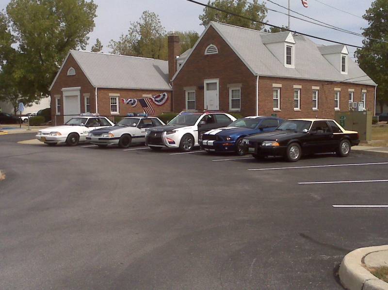 Black 1993 Ford Mustang coupe with yellow roof parked in a lot