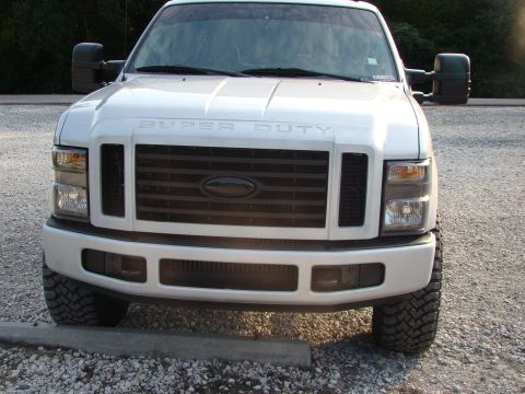 2008 Ford F-250 - This white Ford Super Duty truck is shown from the front, a black grille and large side mirrors.