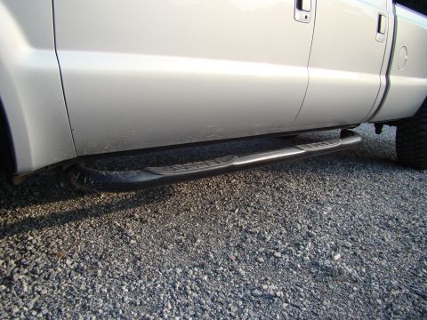 2008 Ford F-250 - Side view of a silver truck showing the passenger side step bars.