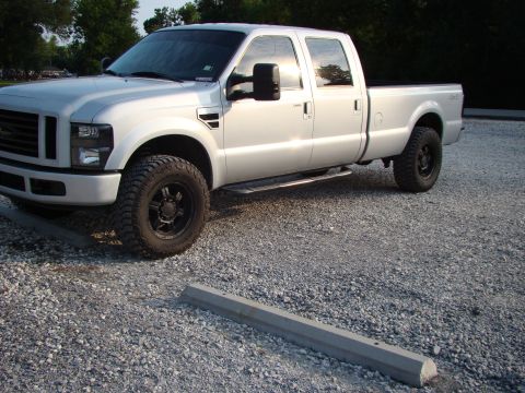 2008 Ford F-250 - A silver 2008 Ford F-250 Super Duty pickup truck is parked on a gravel lot.
