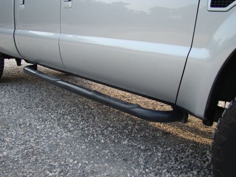 2008 Ford F-250 - Side profile of a silver pickup truck, highlighting its black tubular running boards.