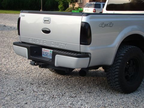2008 Ford F-250 - The rear of a silver pickup truck is shown, a "SUPER DUTY" tailgate and a "4x4" decal on the fender.