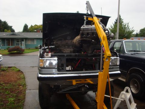 1989 Ford Bronco - Engine removal in progress on a 1989 Ford Bronco, with a second truck visible.