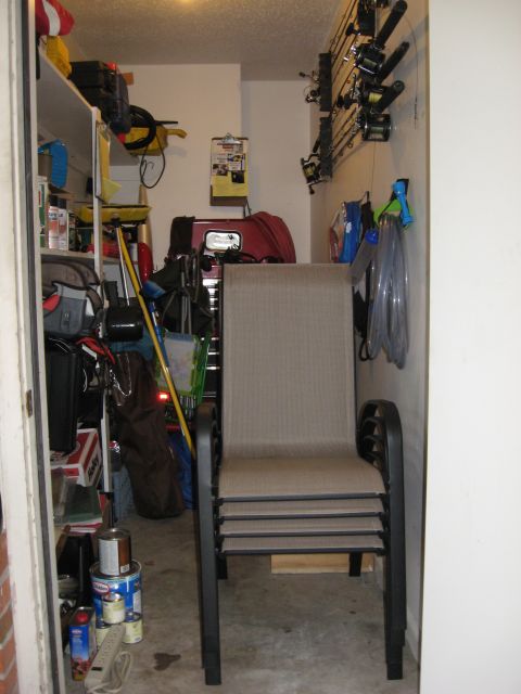 1986 Ford Bronco - A garage scene shows stacked chairs, fishing rods, and various stored items.