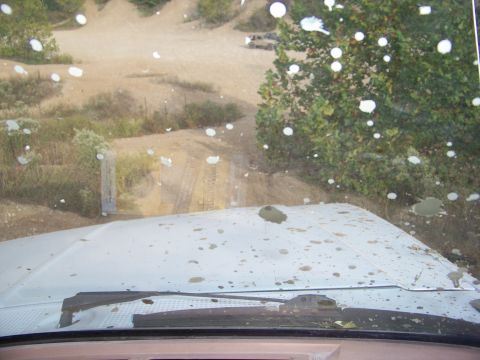 1989 Ford Bronco - Driving through a muddy, off-road area with a dirty windshield.