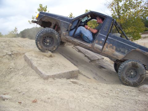 1989 Ford Bronco - A driver navigates a challenging off-road course in a modified truck.