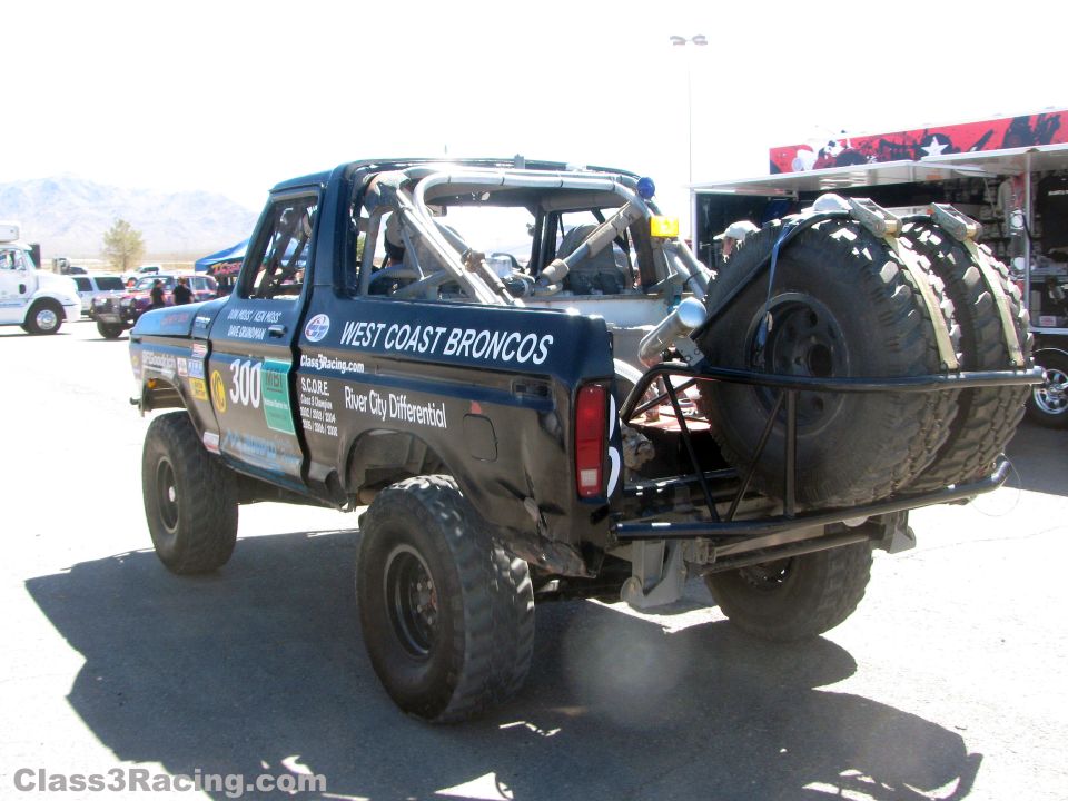 Rear of black West Coast Broncos number 300 race truck with two spare tires