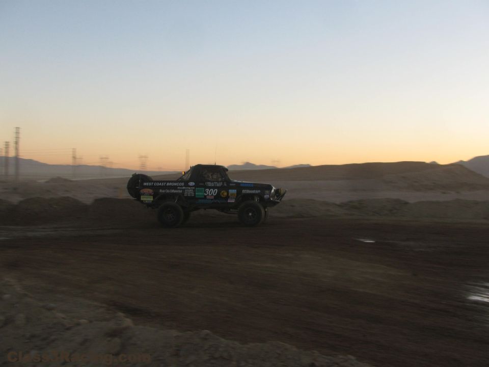 West Coast Broncos number 300 off-road truck on desert track at dusk