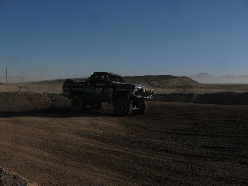 Number 300 off-road race truck on a dusty desert course